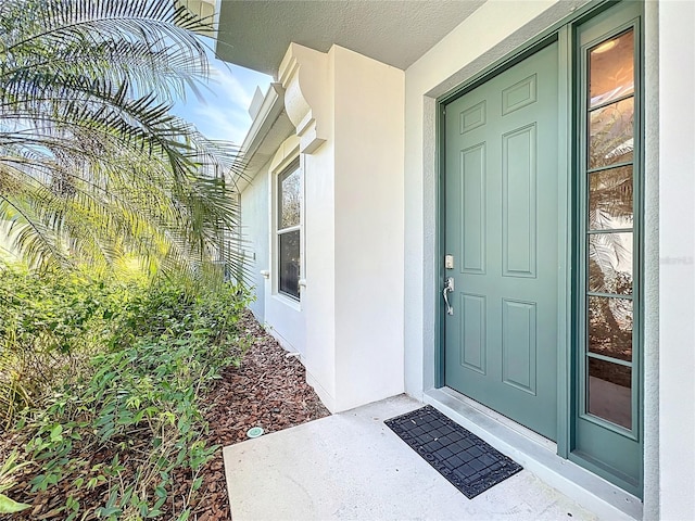 doorway to property with stucco siding