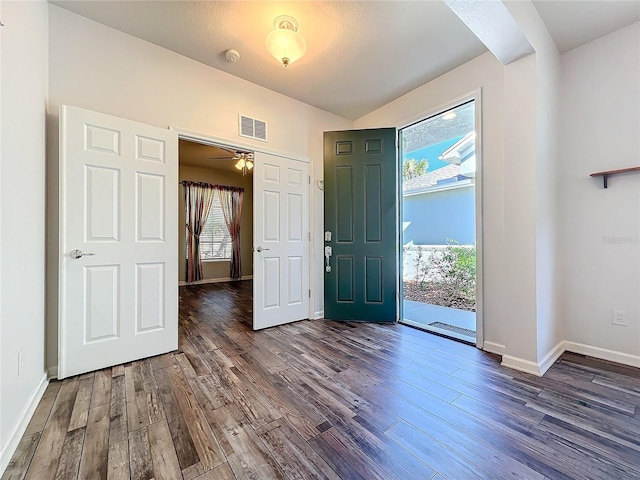 foyer featuring dark wood finished floors, visible vents, and baseboards