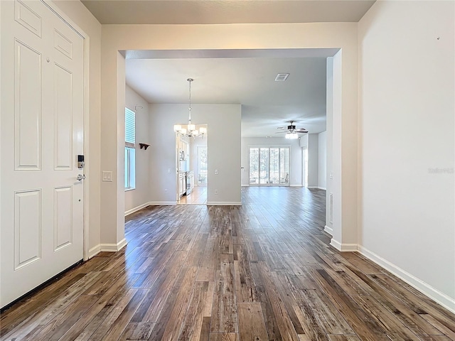 entrance foyer featuring baseboards, visible vents, dark wood finished floors, and ceiling fan with notable chandelier