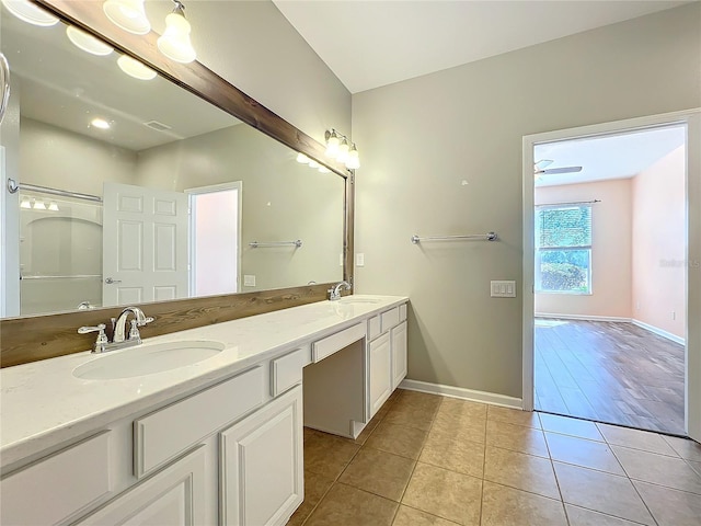 bathroom with baseboards, a sink, and tile patterned floors