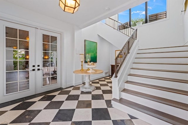 interior space featuring stairs, french doors, visible vents, and dark floors