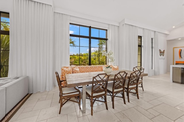 dining room with breakfast area, stone tile flooring, and recessed lighting