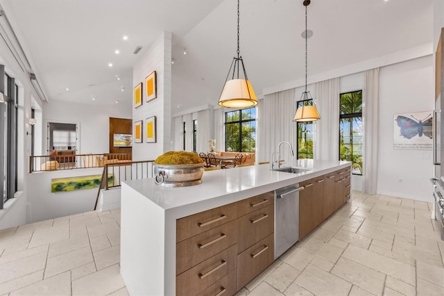 kitchen with stone tile floors, dishwasher, modern cabinets, and a sink