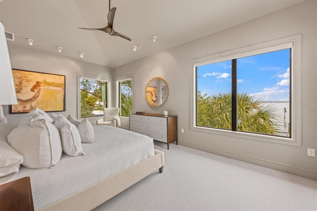 bedroom featuring visible vents, baseboards, ceiling fan, vaulted ceiling, and carpet flooring