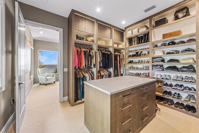 walk in closet featuring visible vents and light colored carpet