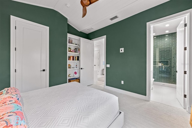 bedroom with visible vents, a fireplace, carpet flooring, baseboards, and vaulted ceiling