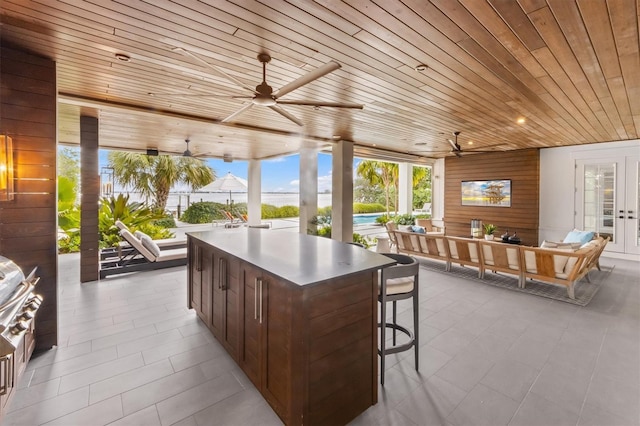 view of patio with outdoor lounge area, french doors, and ceiling fan