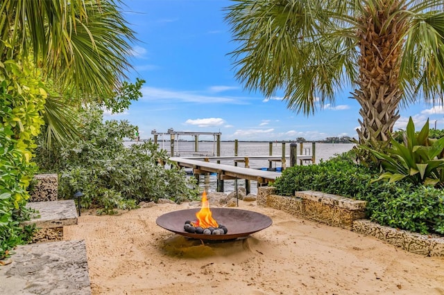 exterior space with an outdoor fire pit and a boat dock