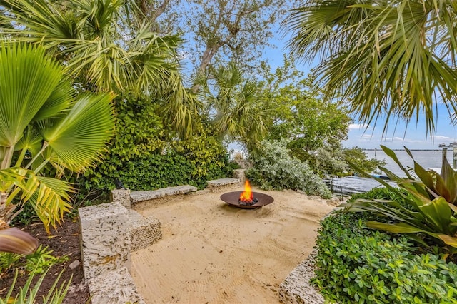 view of yard with an outdoor fire pit