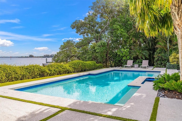 pool with a patio and a water view