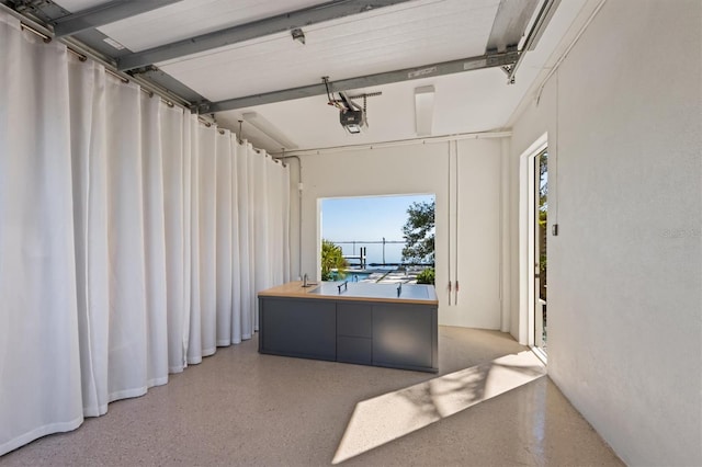 hall featuring light speckled floor