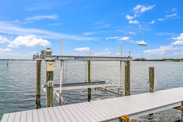 dock area with a water view and boat lift