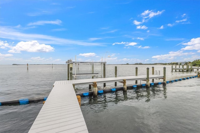 dock area with a water view and boat lift