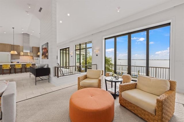 living room featuring recessed lighting, visible vents, and high vaulted ceiling