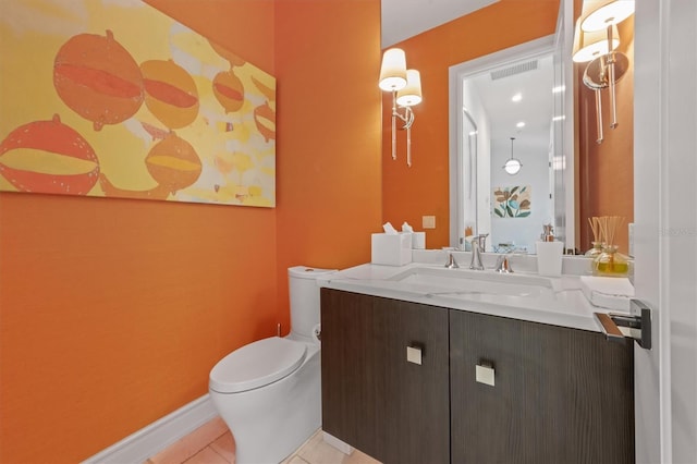 bathroom featuring visible vents, baseboards, toilet, tile patterned floors, and vanity