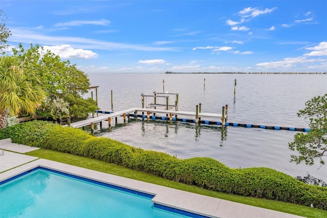 exterior space featuring an outdoor pool and a water view