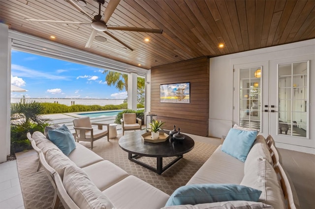 view of patio / terrace featuring a fenced in pool, an outdoor hangout area, a ceiling fan, and french doors