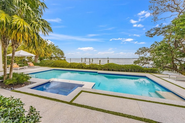 pool featuring a water view, an in ground hot tub, and a patio area