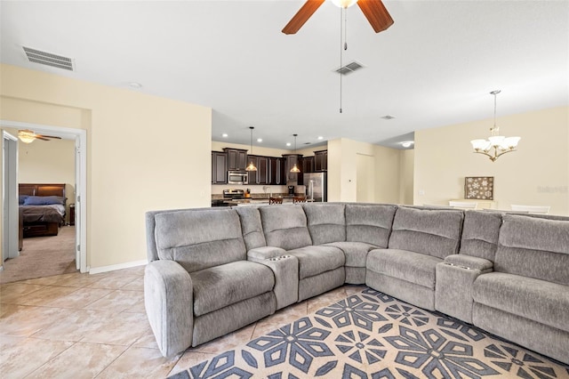 living area with light tile patterned floors, recessed lighting, visible vents, and ceiling fan with notable chandelier