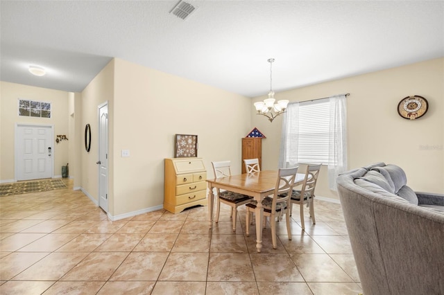 dining room featuring light tile patterned floors, a chandelier, visible vents, and baseboards