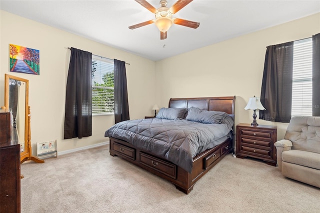 bedroom with baseboards, a ceiling fan, and light colored carpet