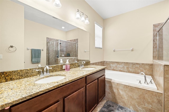 full bathroom featuring double vanity, a sink, a shower stall, and a bath