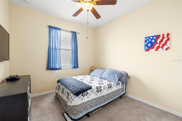 bedroom with light colored carpet, ceiling fan, and baseboards