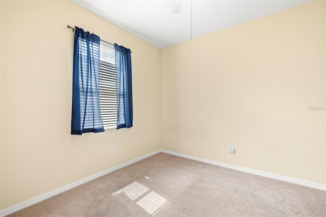 carpeted empty room with baseboards