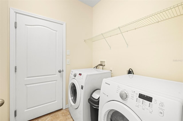 laundry room featuring light tile patterned floors, laundry area, and washer and dryer