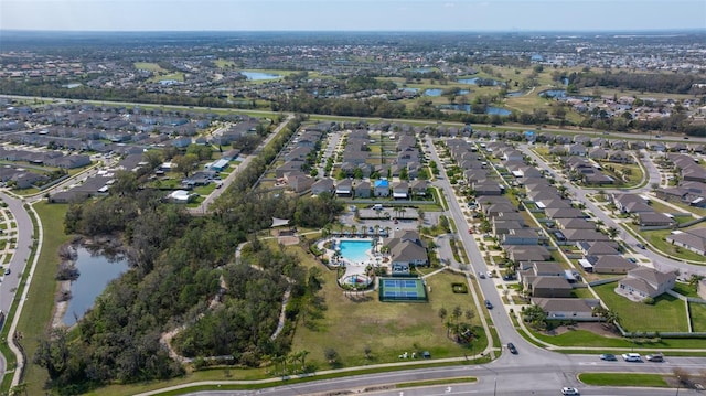 drone / aerial view featuring a water view and a residential view