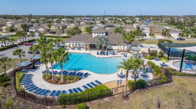 pool featuring a residential view, a patio area, and fence