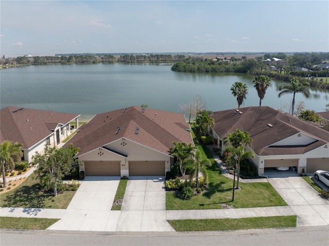 birds eye view of property with a water view