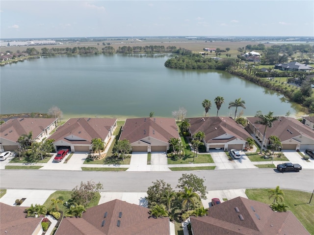 birds eye view of property with a water view and a residential view