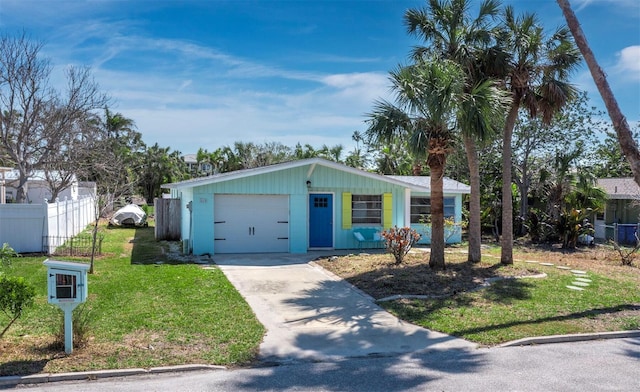 single story home with driveway, a front yard, an attached garage, and fence