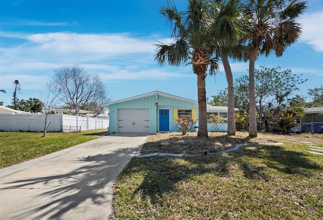 mid-century home with a front lawn, concrete driveway, a garage, and fence