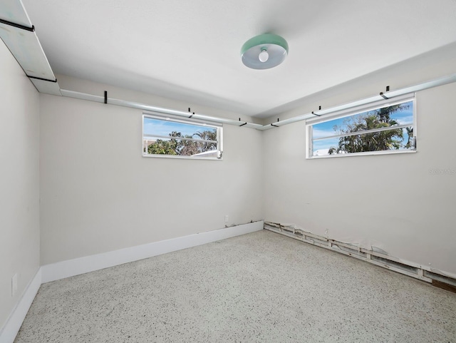 spare room featuring baseboards