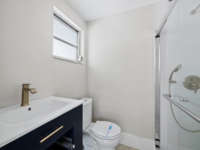 full bath with vanity, toilet, baseboards, and a stall shower