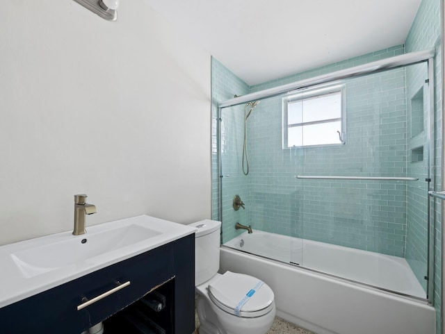 bathroom with enclosed tub / shower combo, toilet, and vanity