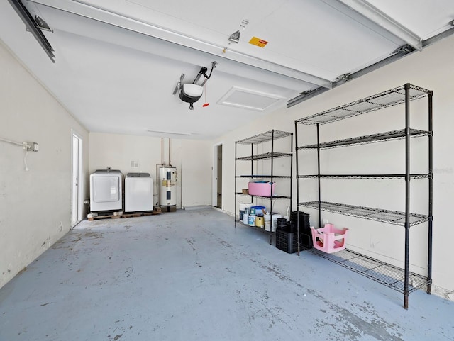 garage with water heater and washing machine and clothes dryer