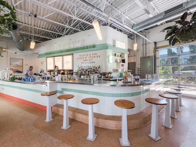 bar with speckled floor, a community bar, and visible vents