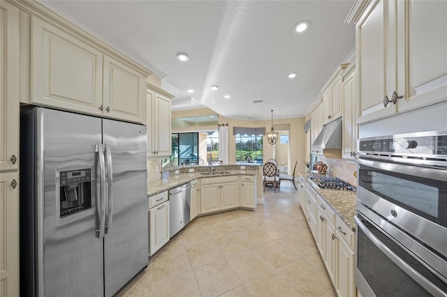7108 Callander Cv, Lakewood Ranch, FL 34202 - kitchen with stainless steel appliances, cream cabinetry, a sink, and under cabinet range hood