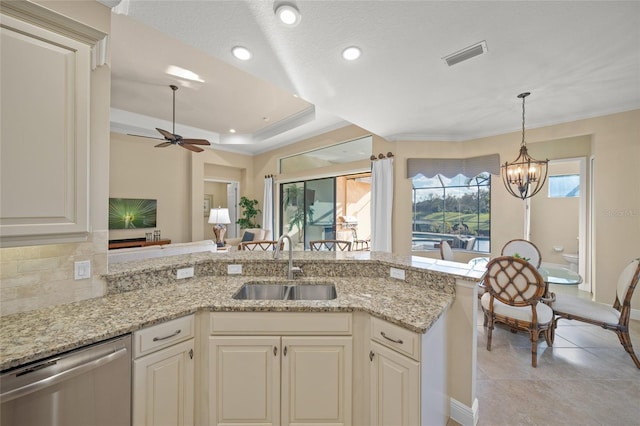 7108 Callander Cv, Lakewood Ranch, FL 34202 - kitchen featuring a sink, visible vents, backsplash, dishwasher, and a tray ceiling