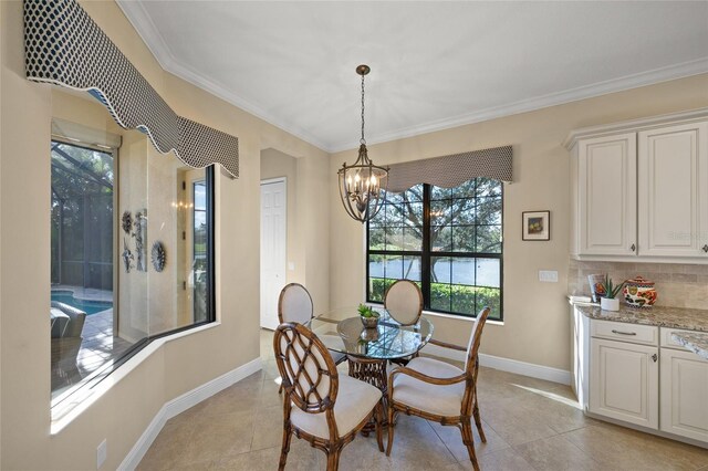 7108 Callander Cv, Lakewood Ranch, FL 34202 - dining area with a notable chandelier, light tile patterned floors, baseboards, and crown molding