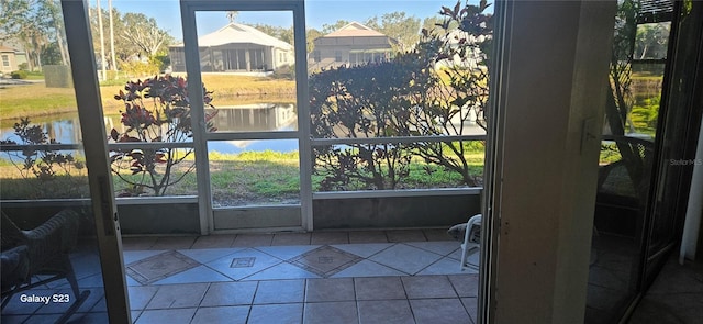 unfurnished sunroom featuring a water view