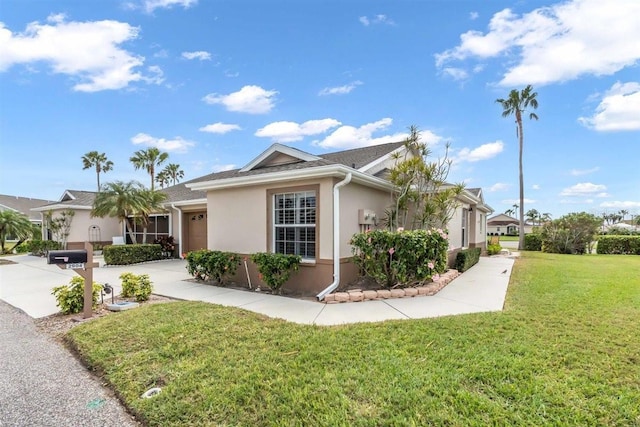 view of front of property featuring a front lawn, concrete driveway, a garage, and stucco siding