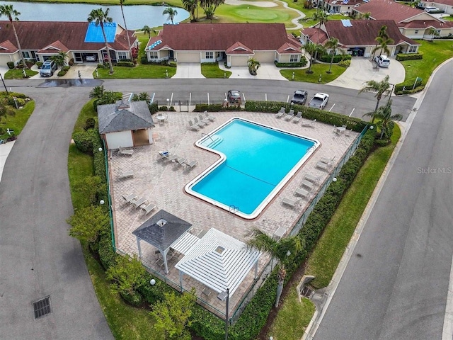 drone / aerial view with a water view and a residential view