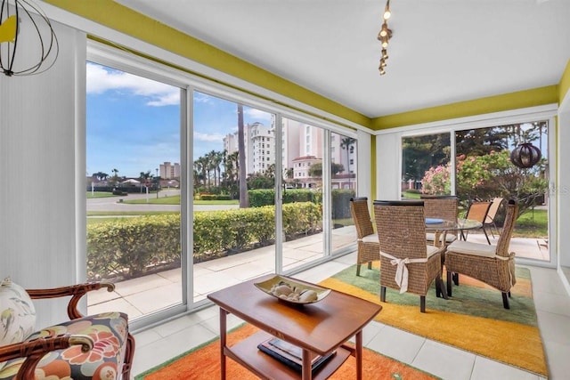 sunroom featuring a city view and a healthy amount of sunlight