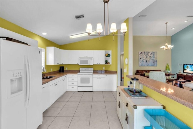 kitchen featuring white appliances, light tile patterned floors, lofted ceiling, a sink, and hanging light fixtures