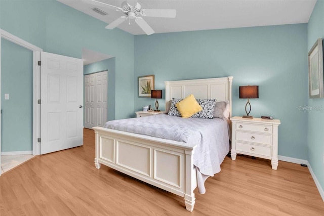 bedroom with a closet, baseboards, visible vents, and light wood-style flooring