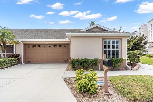 ranch-style home featuring an attached garage, driveway, and stucco siding